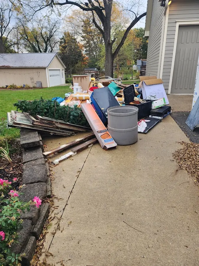 Dumpster being loaded with debris for Commercial Dumpster Rental in Chesterland